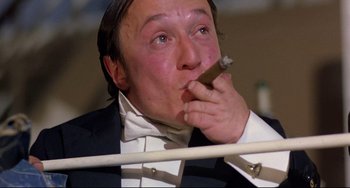 Movie still from “Time Bandits” (1981), directed by Terry Gilliam – A person holding a cigar in his mouth; Close Up shot, Low angle