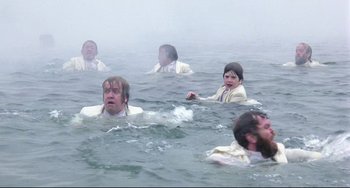 Movie still from “Time Bandits” (1981), directed by Terry Gilliam – A group of people in the water in the ocean; Wide shot, High angle