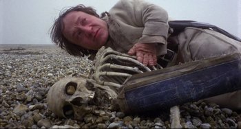 Movie still from “Time Bandits” (1981), directed by Terry Gilliam – A woman laying on the ground next to a skeleton; Medium shot, Low angle