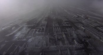 Movie still from “Time Bandits” (1981), directed by Terry Gilliam – An aerial view of a building in the middle of a city; Extreme Wide shot, High angle