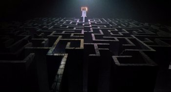 Movie still from “Time Bandits” (1981), directed by Terry Gilliam – A lit candle in the middle of an empty maze; Extreme Wide shot, High angle