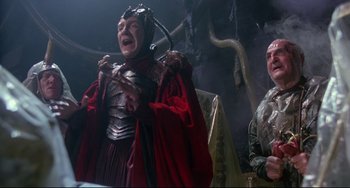 Movie still from “Time Bandits” (1981), directed by Terry Gilliam – A man dressed in a costume and holding a sword; Medium shot, Low angle