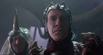 Movie still from “Time Bandits” (1981), directed by Terry Gilliam – A person wearing a helmet; Close Up shot, Low angle