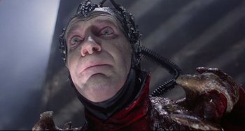 Movie still from “Time Bandits” (1981), directed by Terry Gilliam – A man with a helmet on is looking at the camera; Close Up shot, Low angle