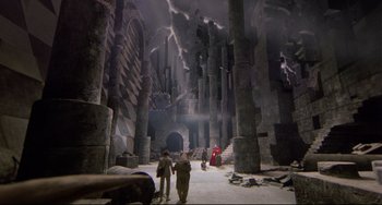 Movie still from “Time Bandits” (1981), directed by Terry Gilliam – People are walking through a tunnel in the dark; Extreme Wide shot, High angle