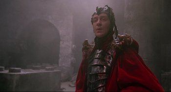 Movie still from “Time Bandits” (1981), directed by Terry Gilliam – A man in a red jacket and a metal helmet; Medium shot, Low angle