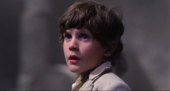 Movie still from “Time Bandits” (1981), directed by Terry Gilliam – A young boy with blue eyes looking at the camera; Close Up shot, Low angle