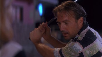 Movie still from “Tin Cup” (1996), directed by Ron Shelton – A person brushing his hair; Close Up shot, Low angle