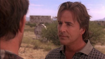 Movie still from “Tin Cup” (1996), directed by Ron Shelton – A man is talking to another man in the desert; Close Up shot, Over the shoulder angle