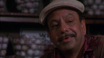 Movie still from “Tin Cup” (1996), directed by Ron Shelton – A person wearing a hat; Close Up shot, Low angle