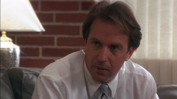 Movie still from “Tin Cup” (1996), directed by Ron Shelton – A person wearing a white shirt and tie; Close Up shot, Over the shoulder angle