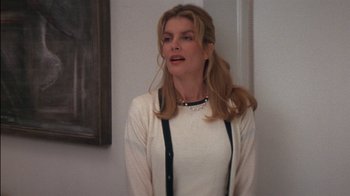 Movie still from “Tin Cup” (1996), directed by Ron Shelton – A woman with long blonde hair wearing a white sweater; Medium shot, Over the shoulder angle