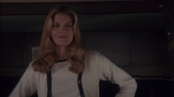 Movie still from “Tin Cup” (1996), directed by Ron Shelton – A woman with long blonde hair wearing a white sweater; Medium shot, Low angle