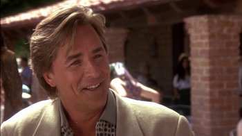 Movie still from “Tin Cup” (1996), directed by Ron Shelton – A person wearing a suit and smiling; Close Up shot, Over the shoulder angle