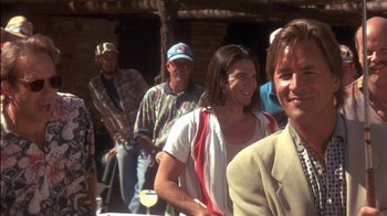 Movie still from “Tin Cup” (1996), directed by Ron Shelton – A group of people standing next to each other; Medium shot, Over the shoulder angle