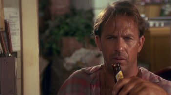 Movie still from “Tin Cup” (1996), directed by Ron Shelton – A person eating a banana; Close Up shot, Low angle