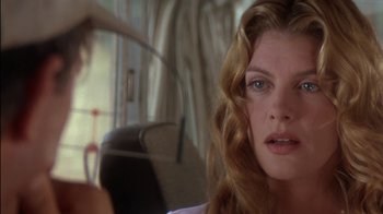 Movie still from “Tin Cup” (1996), directed by Ron Shelton – A person sitting in a chair; Close Up shot, Over the shoulder angle