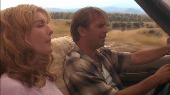 Movie still from “Tin Cup” (1996), directed by Ron Shelton – A man and a woman sitting in the back of a car; Close Up shot, Over the shoulder angle