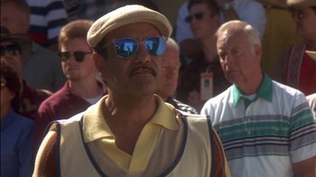 Movie still from “Tin Cup” (1996), directed by Ron Shelton – A group of men standing next to each other wearing hats; Close Up shot, Low angle