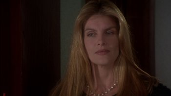 Movie still from “Tin Cup” (1996), directed by Ron Shelton – A person with long hair wearing a necklace; Close Up shot, Over the shoulder angle