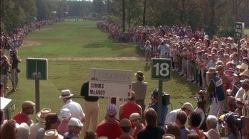Movie still from “Tin Cup” (1996), directed by Ron Shelton – A crowd of people standing around a golf course; Extreme Wide shot, High angle