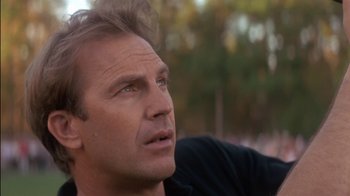 Movie still from “Tin Cup” (1996), directed by Ron Shelton – A man's face with trees in the background; Close Up shot, Low angle