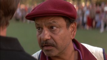 Movie still from “Tin Cup” (1996), directed by Ron Shelton – A person wearing a hat; Close Up shot, Low angle