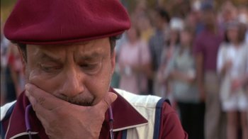 Movie still from “Tin Cup” (1996), directed by Ron Shelton – A person wearing a red hat; Close Up shot, High angle