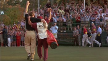 Movie still from “Tin Cup” (1996), directed by Ron Shelton – A couple of people that are in the grass; Extreme Wide shot, Low angle