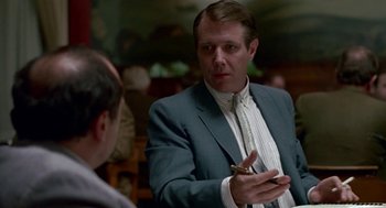 Movie still from “Tin Men” (1987), directed by Barry Levinson – A man in a suit talking to another man in a suit; Close Up shot, Over the shoulder angle