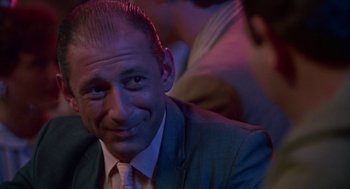 Movie still from “Tin Men” (1987), directed by Barry Levinson – A person wearing a suit and tie; Close Up shot, Low angle