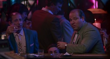Movie still from “Tin Men” (1987), directed by Barry Levinson – A group of people sitting at a bar; Medium shot, Over the shoulder angle