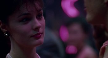 Movie still from “Tin Men” (1987), directed by Barry Levinson – A woman's face in front of purple lights; Close Up shot, Over the shoulder angle