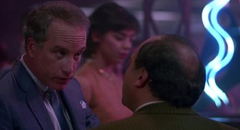 Movie still from “Tin Men” (1987), directed by Barry Levinson – A man and a woman talking to another man in a suit; Close Up shot, Over the shoulder angle