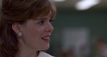 Movie still from “Tin Men” (1987), directed by Barry Levinson – A person with short brown hair; Close Up shot, Low angle