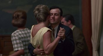 Movie still from “Tin Men” (1987), directed by Barry Levinson – A man and a woman are dancing together; Close Up shot, Low angle