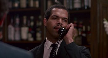 Movie still from “Tin Men” (1987), directed by Barry Levinson – A man talking on a phone while wearing a suit and tie; Close Up shot, Low angle