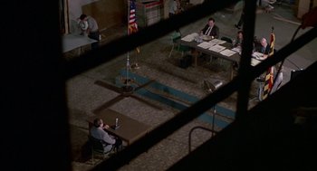 Movie still from “Tin Men” (1987), directed by Barry Levinson – A group of people sitting at a table in a room; Extreme Wide shot, High angle