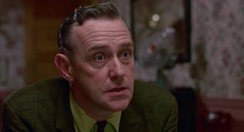 Movie still from “Tin Men” (1987), directed by Barry Levinson – An older man in a suit and tie looking to his left; Close Up shot, Low angle