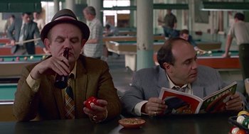Movie still from “Tin Men” (1987), directed by Barry Levinson – A couple of men sitting at a table with food; Medium shot, High angle
