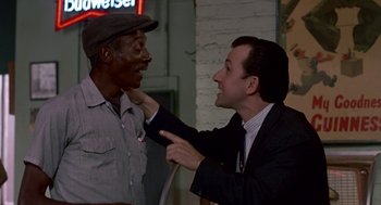 Movie still from “Tin Men” (1987), directed by Barry Levinson – A man in a suit and a man in a hat; Medium shot, Over the shoulder angle