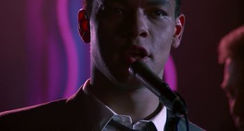 Movie still from “Tin Men” (1987), directed by Barry Levinson – A man in a suit and tie smoking a pipe; Close Up shot, Low angle