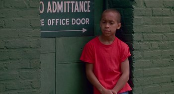 Movie still from “Tin Men” (1987), directed by Barry Levinson – A young boy standing in front of an office door; Medium shot, High angle