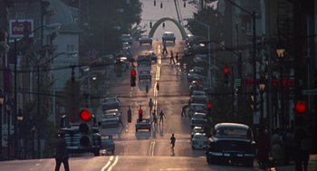 Movie still from “Tin Men” (1987), directed by Barry Levinson – A street filled with lots of cars and people on the sidewalk; Extreme Wide shot, High angle