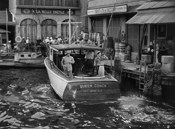 Movie still from “To Have and Have Not” (1944), directed by Howard Hawks – A black and white photo of people on a boat; Extreme Wide shot, High angle