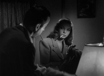 Movie still from “To Have and Have Not” (1944), directed by Howard Hawks – A man and a woman are looking at each other; Medium shot, Over the shoulder angle