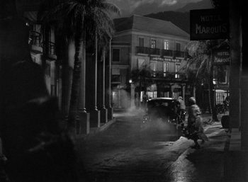 Movie still from “To Have and Have Not” (1944), directed by Howard Hawks – A black - and - white photo of a city street at night; Extreme Wide shot, High angle
