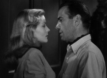 Movie still from “To Have and Have Not” (1944), directed by Howard Hawks – A man and a woman face to face in a black and white photo; Close Up shot, Low angle