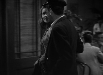 Movie still from “To Have and Have Not” (1944), directed by Howard Hawks – A man and a woman standing next to each other; Medium shot, Over the shoulder angle