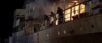 Movie still from “Tobruk” (1967), directed by Arthur Hiller – A group of men standing on top of a boat; Extreme Wide shot, Low angle